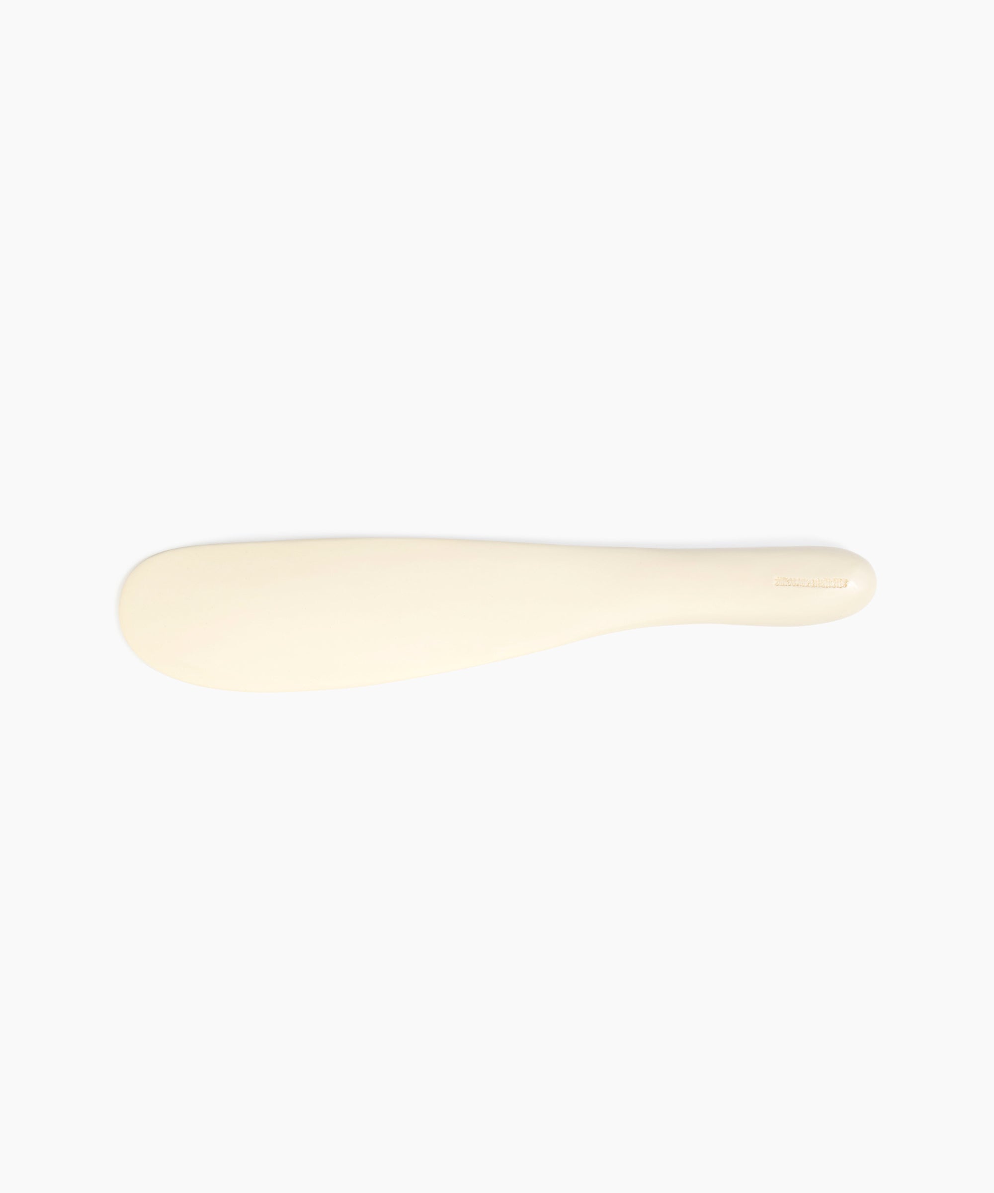 Dinosaur Designs Temple Cake Knife in Cream — handcrafted cream resin cake knife with smooth tapered blade and rounded handle
