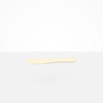 Dinosaur Designs Temple Cake Knife in Cream — handcrafted cream resin cake knife with smooth tapered blade and rounded handle
