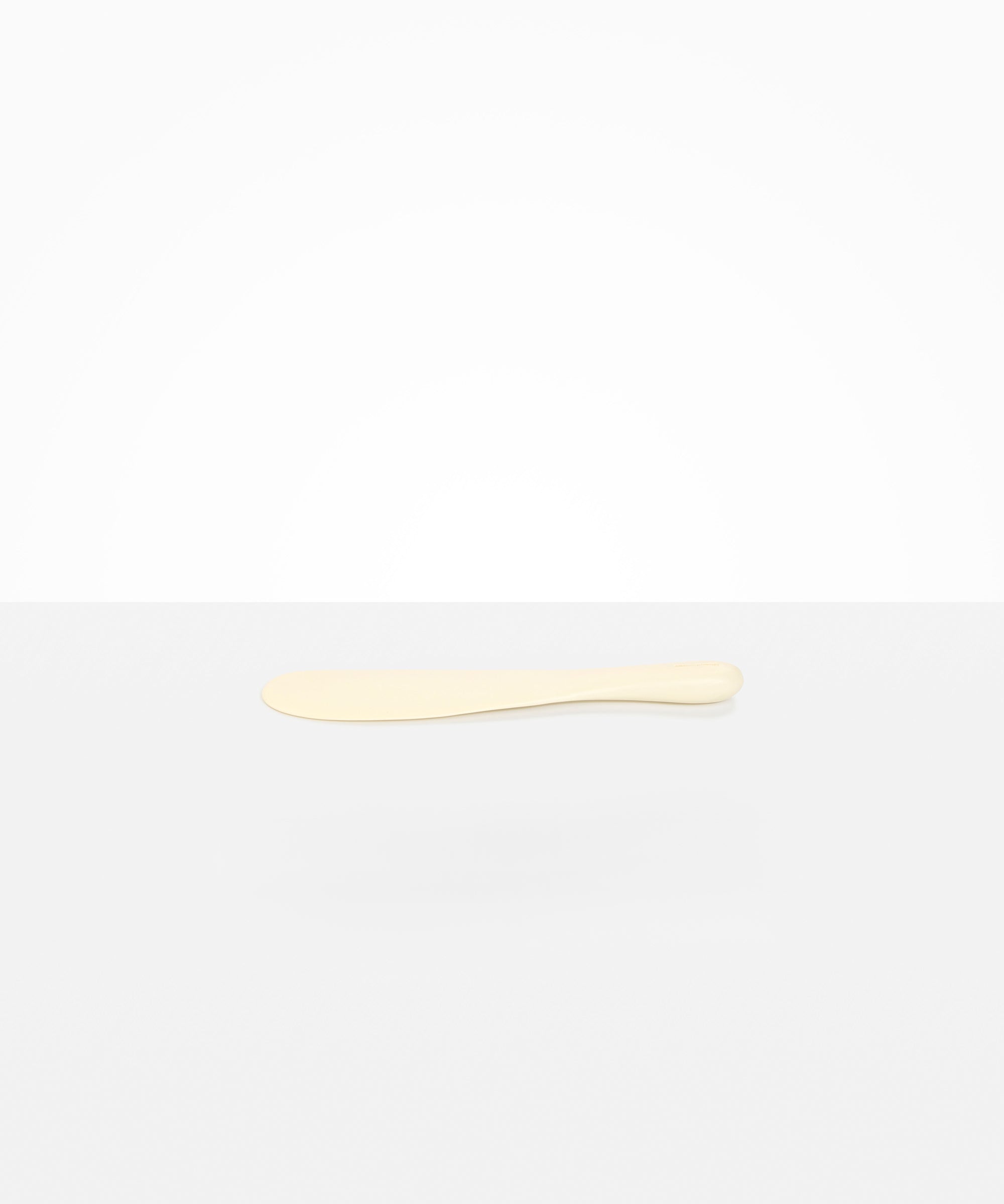 Dinosaur Designs Temple Cake Knife in Cream — handcrafted cream resin cake knife with smooth tapered blade and rounded handle