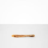 Dinosaur Designs Temple Cake Knife in Light Horn — handcrafted marbled brown, cream and clear resin cake knife with smooth tapered blade and rounded handle