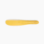 Dinosaur Designs Temple Cake Knife in Pollen — handcrafted marbled yellow and clear resin cake knife with smooth tapered blade and rounded handle