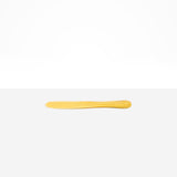 Dinosaur Designs Temple Cake Knife in Pollen — handcrafted marbled yellow and clear resin cake knife with smooth tapered blade and rounded handle