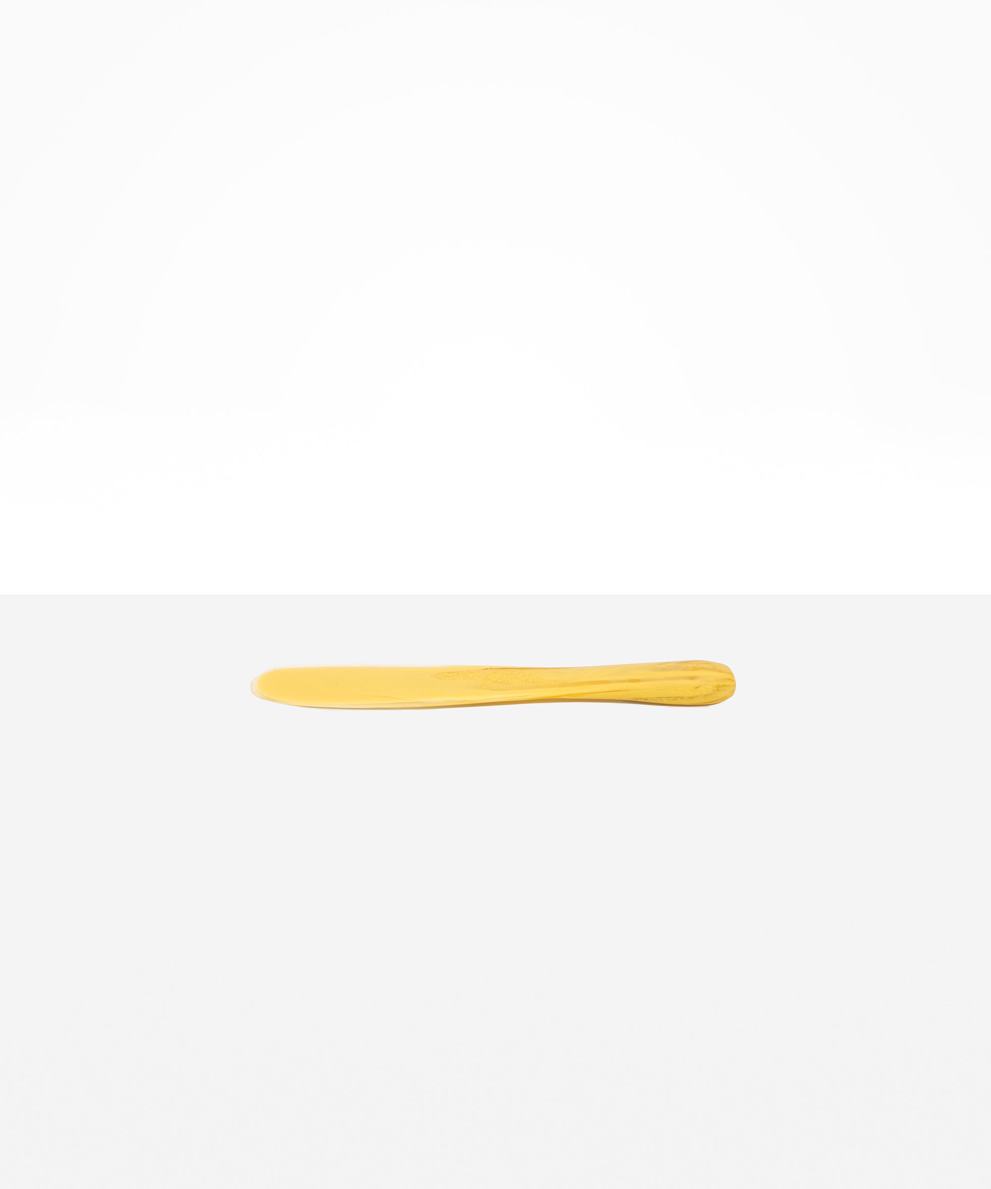 Dinosaur Designs Temple Cake Knife in Pollen — handcrafted marbled yellow and clear resin cake knife with smooth tapered blade and rounded handle