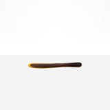 Dinosaur Designs Temple Cake Knife in Tortoise — handcrafted marbled amber and black resin cake knife with smooth tapered blade and rounded handle
