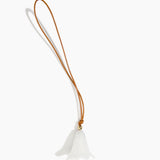 Dinosaur Designs Flower Bag Charm in Chalk Swirl colour with Brass bead — handcrafted marbled off-white resin bell-shaped flower bag charm with tan leather hanging loop and brass bead