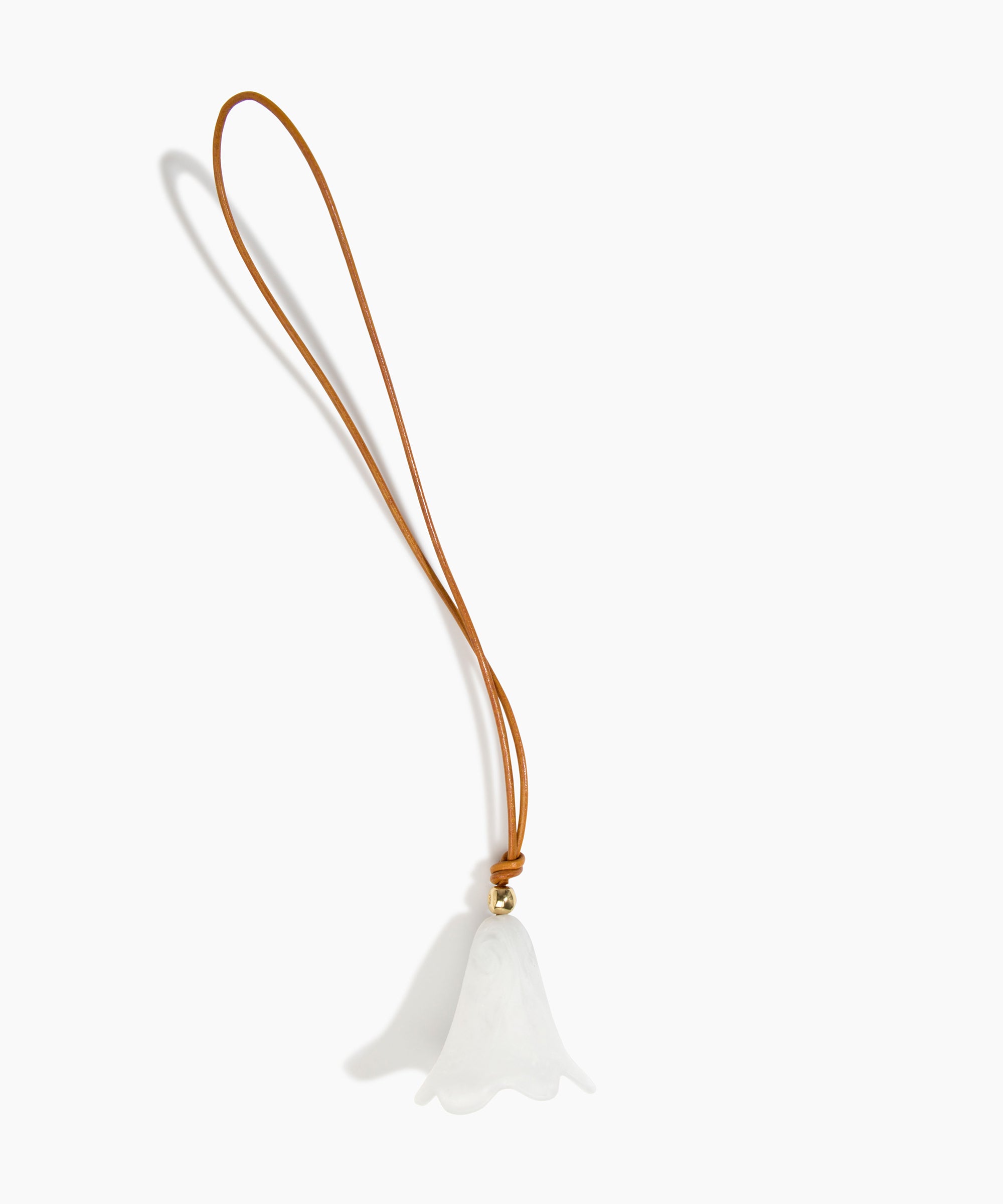 Dinosaur Designs Flower Bag Charm in Chalk Swirl colour with Brass bead — handcrafted marbled off-white resin bell-shaped flower bag charm with tan leather hanging loop and brass bead