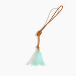 Dinosaur Designs Flower Bag Charm in Mint colour with Brass bead — handcrafted marbled mint blue resin bell-shaped flower bag charm with tan leather hanging loop and brass bead