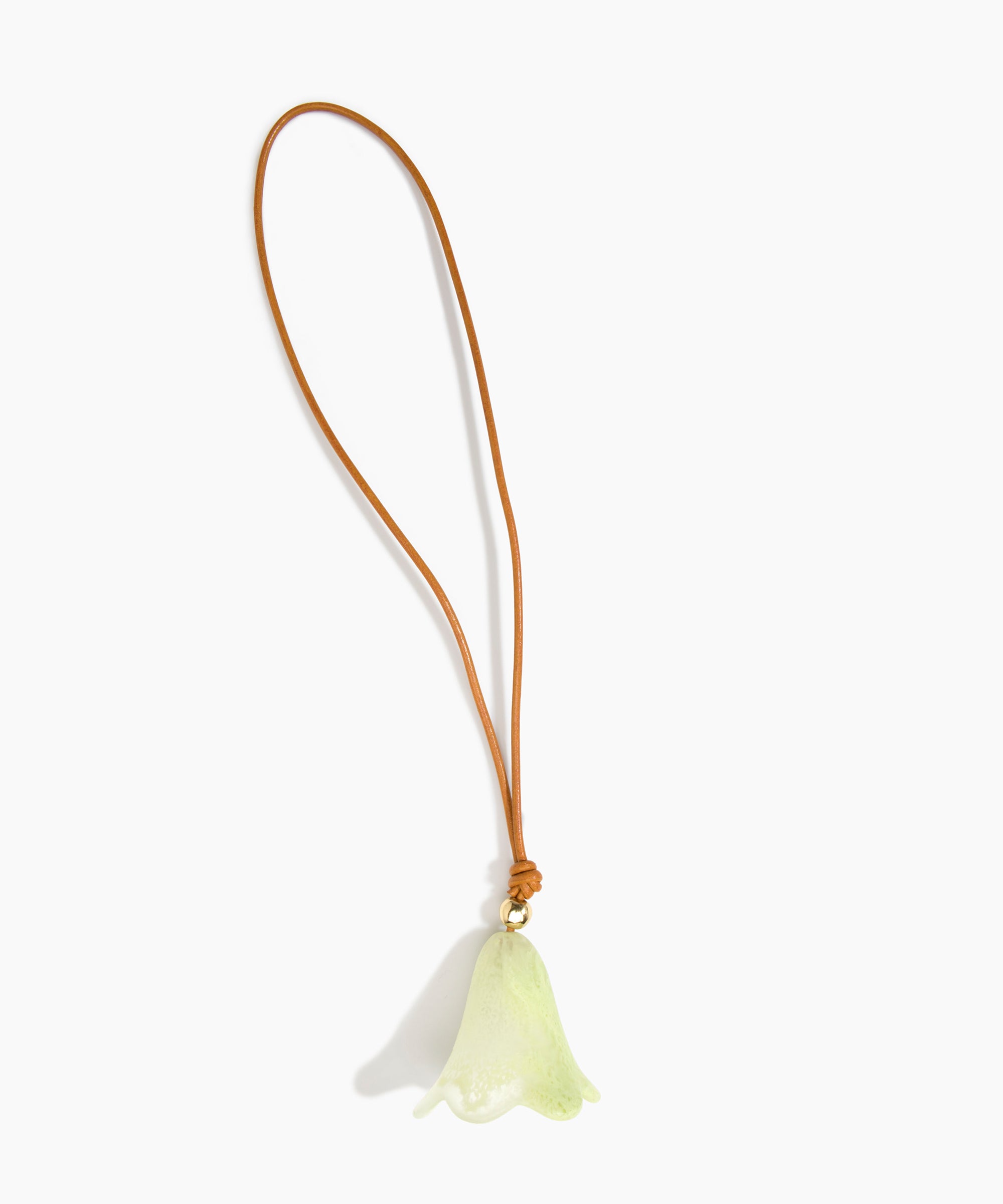 Dinosaur Designs Flower Bag Charm in Pistachio colour with Brass bead — handcrafted marbled pastel green resin bell-shaped flower bag charm with tan leather hanging loop and brass bead