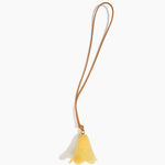 Dinosaur Designs Flower Bag Charm in Pollen colour with Brass bead — handcrafted marbled yellow resin bell-shaped flower bag charm with tan leather hanging loop and brass bead