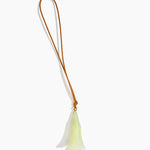 Dinosaur Designs Long Flower Bag Charm in Pistachio colour with Brass bead — handcrafted marbled pastel green resin bell-shaped flower bag charm with tan leather hanging loop and brass bead