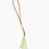 Dinosaur Designs Long Flower Bag Charm in Pistachio colour with Brass bead — handcrafted marbled pastel green resin bell-shaped flower bag charm with tan leather hanging loop and brass bead
