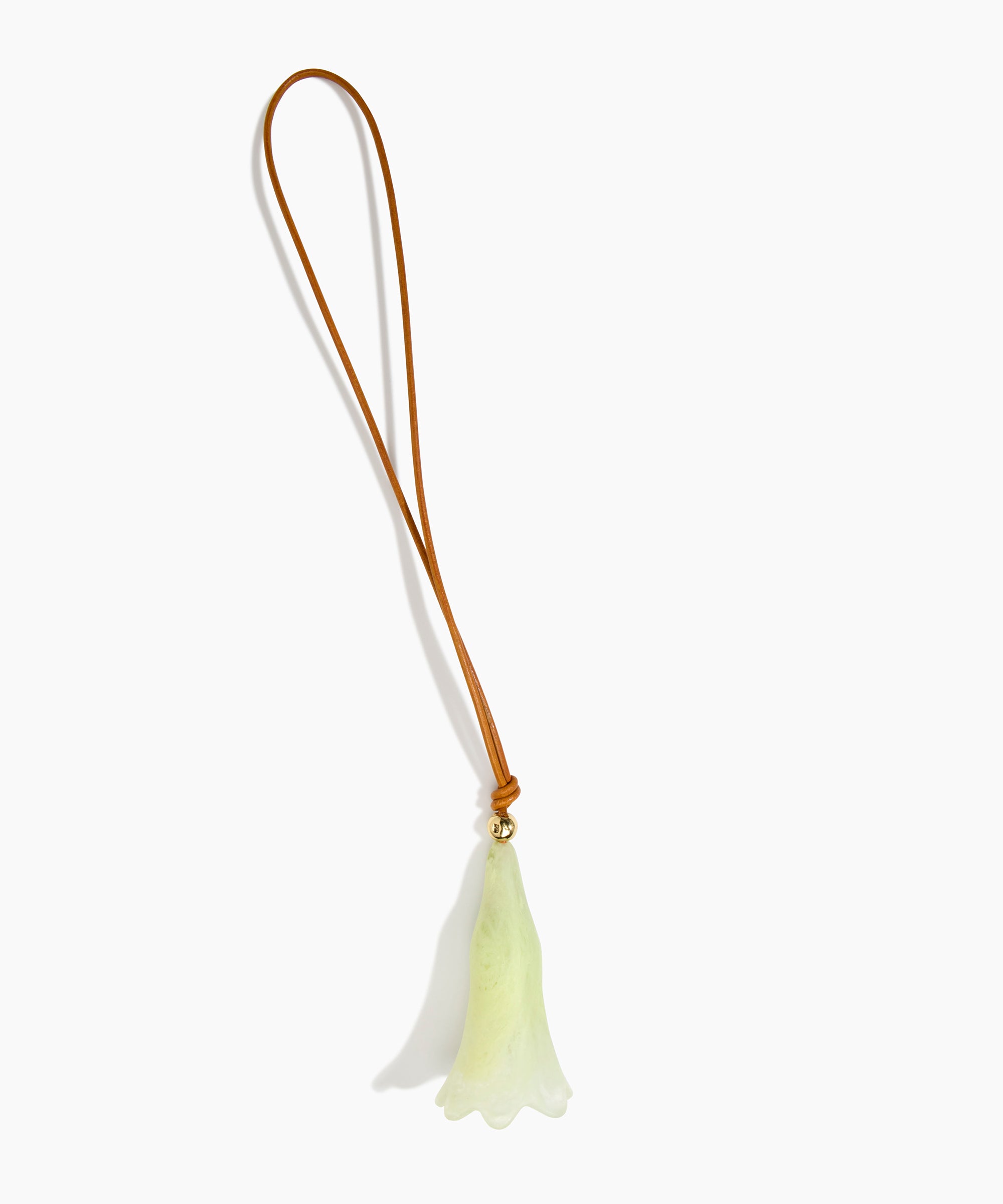 Dinosaur Designs Long Flower Bag Charm in Pistachio colour with Brass bead — handcrafted marbled pastel green resin bell-shaped flower bag charm with tan leather hanging loop and brass bead