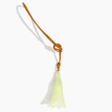 Dinosaur Designs Long Flower Bag Charm in Pistachio colour with Brass bead — handcrafted marbled pastel green resin bell-shaped flower bag charm with tan leather hanging loop and brass bead