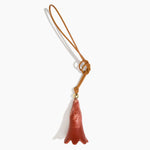 Dinosaur Designs Long Flower Bag Charm in Rust colour with Brass bead — handcrafted marbled terracotta red and cream resin bell-shaped flower bag charm with tan leather hanging loop and brass bead