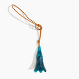 Dinosaur Designs Long Flower Bag Charm in Turquoise colour with Brass bead — handcrafted marbled teal blue resin bell-shaped flower bag charm with tan leather hanging loop and brass bead