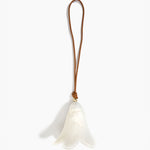 Dinosaur Designs Flower Decoration in Chalk Swirl colour with Brass bead — handcrafted marbled off-white resin bell-shaped flower ornament with tan leather hanging loop and brass bead