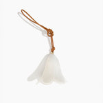 Dinosaur Designs Flower Decoration in Chalk Swirl colour with Brass bead — handcrafted marbled off-white resin bell-shaped flower ornament with tan leather hanging loop and brass bead