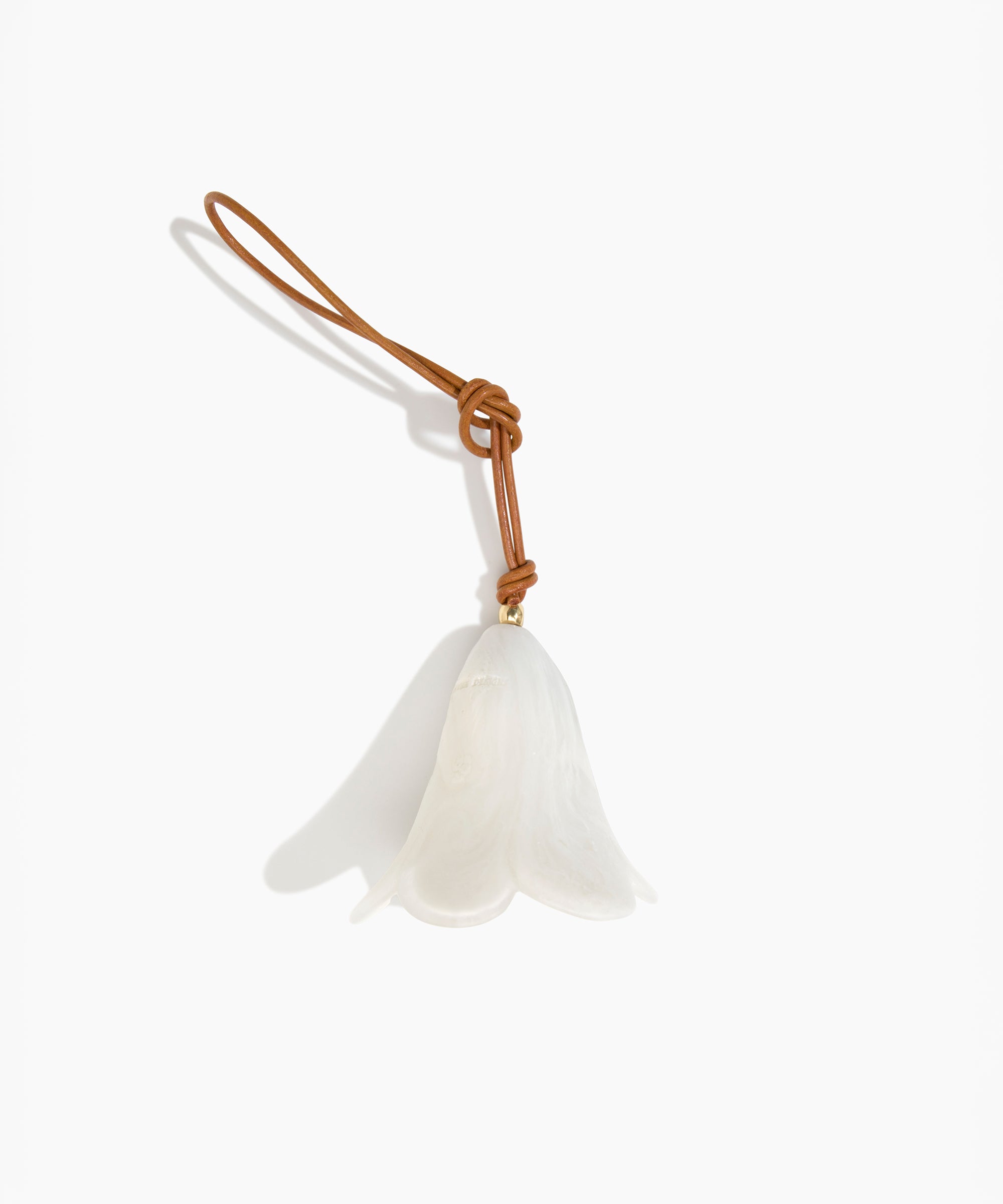 Dinosaur Designs Flower Decoration in Chalk Swirl colour with Brass bead — handcrafted marbled off-white resin bell-shaped flower ornament with tan leather hanging loop and brass bead
