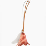 Dinosaur Designs Flower Decoration in Rust colour with Brass bead — handcrafted marbled terracotta red and cream resin bell-shaped flower ornament with tan leather hanging loop and brass bead