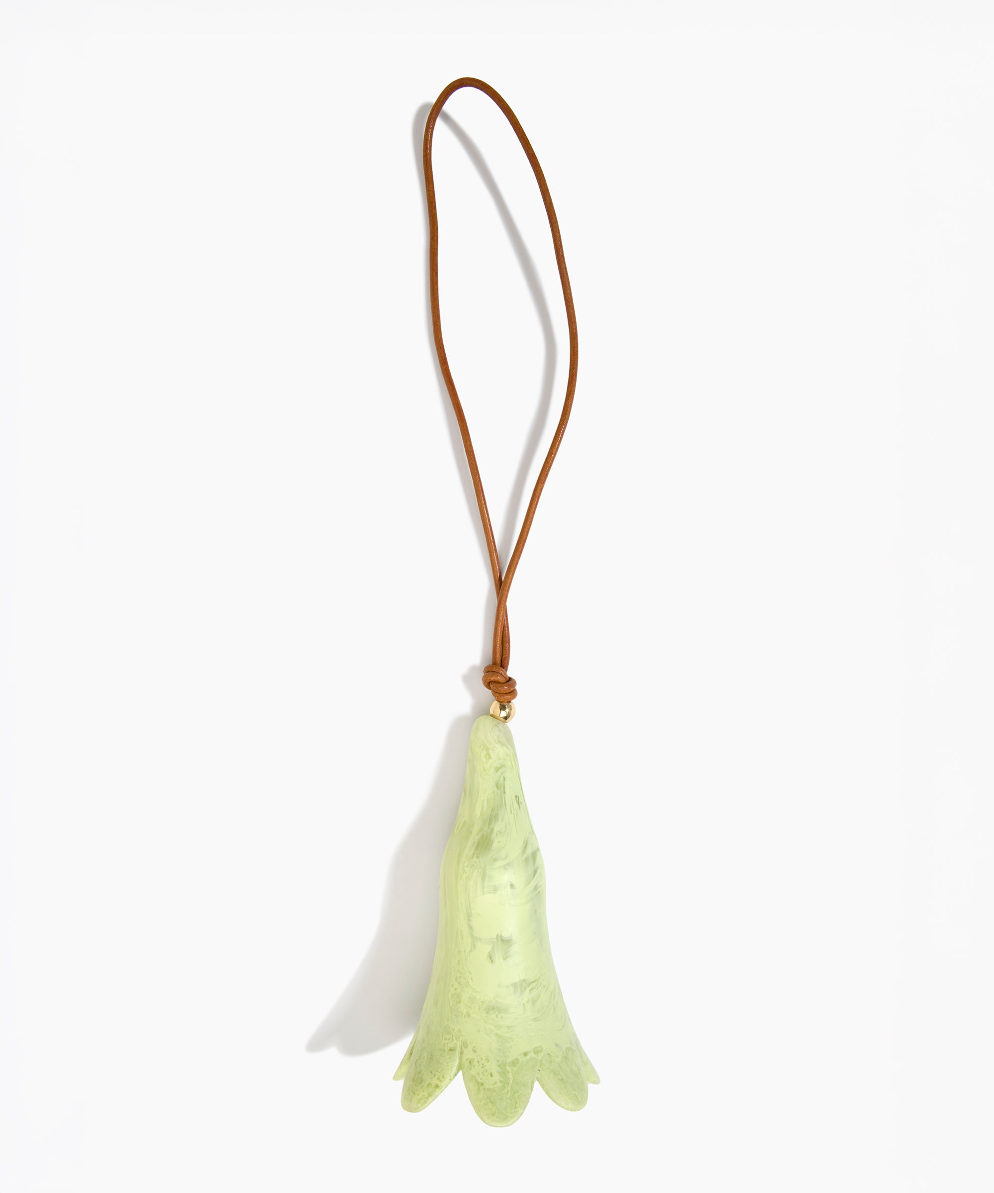 Dinosaur Designs Long Flower Decoration in Pistachio colour with Brass bead — handcrafted marbled pastel green resin bell-shaped flower ornament with tan leather hanging loop and brass bead
