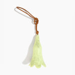 Dinosaur Designs Long Flower Decoration in Pistachio colour with Brass bead — handcrafted marbled pastel green resin bell-shaped flower ornament with tan leather hanging loop and brass bead