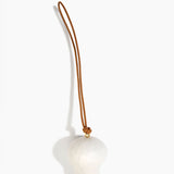 Dinosaur Designs Gumnut Decoration in Chalk Swirl colour with Brass hardware — handcrafted marbled off-white resin gumnut-shaped ornament with tan leather hanging loop and brass bead