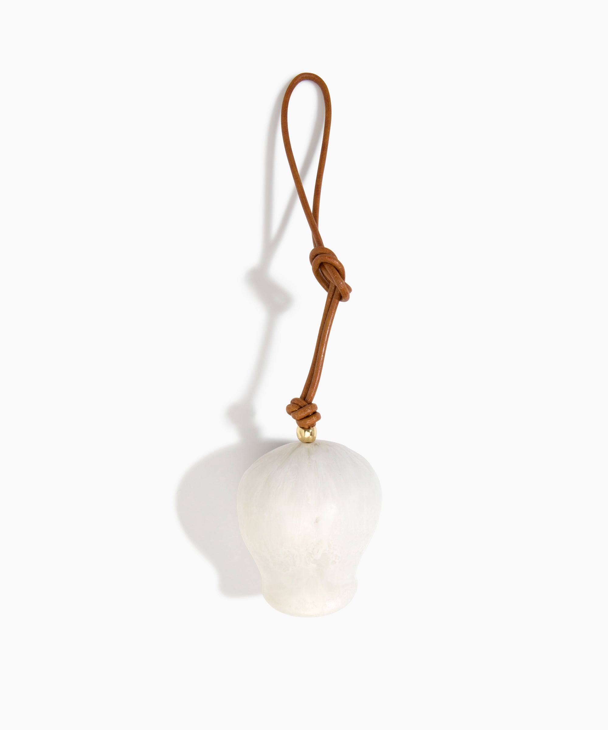 Dinosaur Designs Gumnut Decoration in Chalk Swirl colour with Brass hardware — handcrafted marbled off-white resin gumnut-shaped ornament with tan leather hanging loop and brass bead