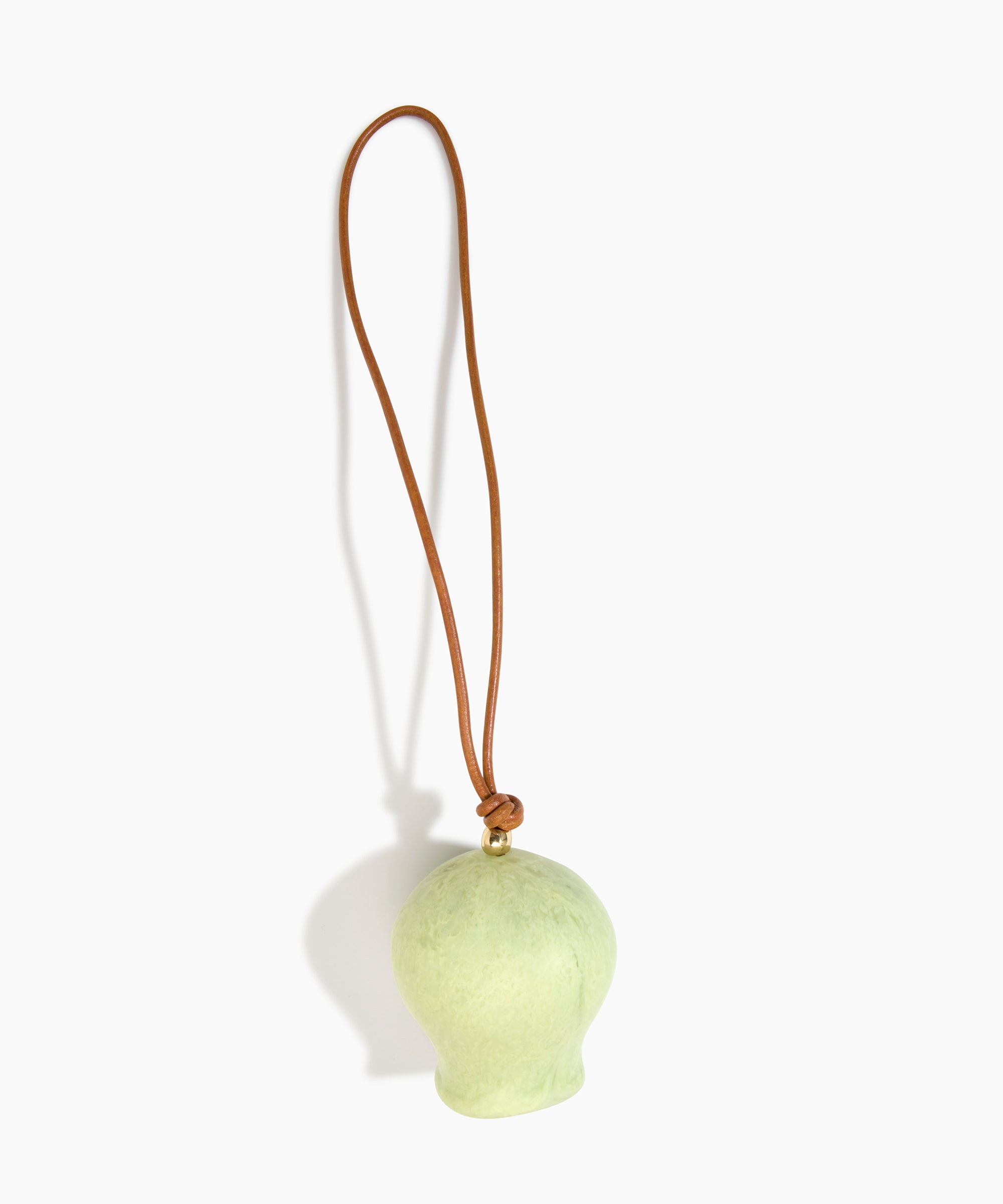 Dinosaur Designs Gumnut Decoration in Pistachio colour with Brass hardware — handcrafted marbled pastel green resin gumnut-shaped ornament with tan leather hanging loop and brass bead