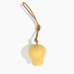 Dinosaur Designs Gumnut Decoration in Pollen colour with Brass hardware — handcrafted marbled yellow resin gumnut-shaped ornament with tan leather hanging loop and brass bead