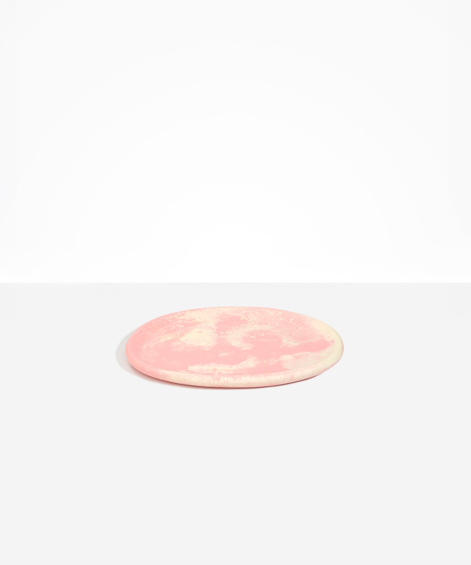 Dinosaur Designs Rock Plate in Blossom — handcrafted marbled pink and cream resin oval flat serving plate with rounded organic edge
