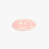 Dinosaur Designs Rock Plate in Blossom — handcrafted marbled pink and cream resin oval flat serving plate with rounded organic edge