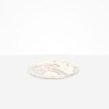 Dinosaur Designs Rock Plate in Pool — handcrafted marbled off-white resin oval flat serving plate with rounded organic edge