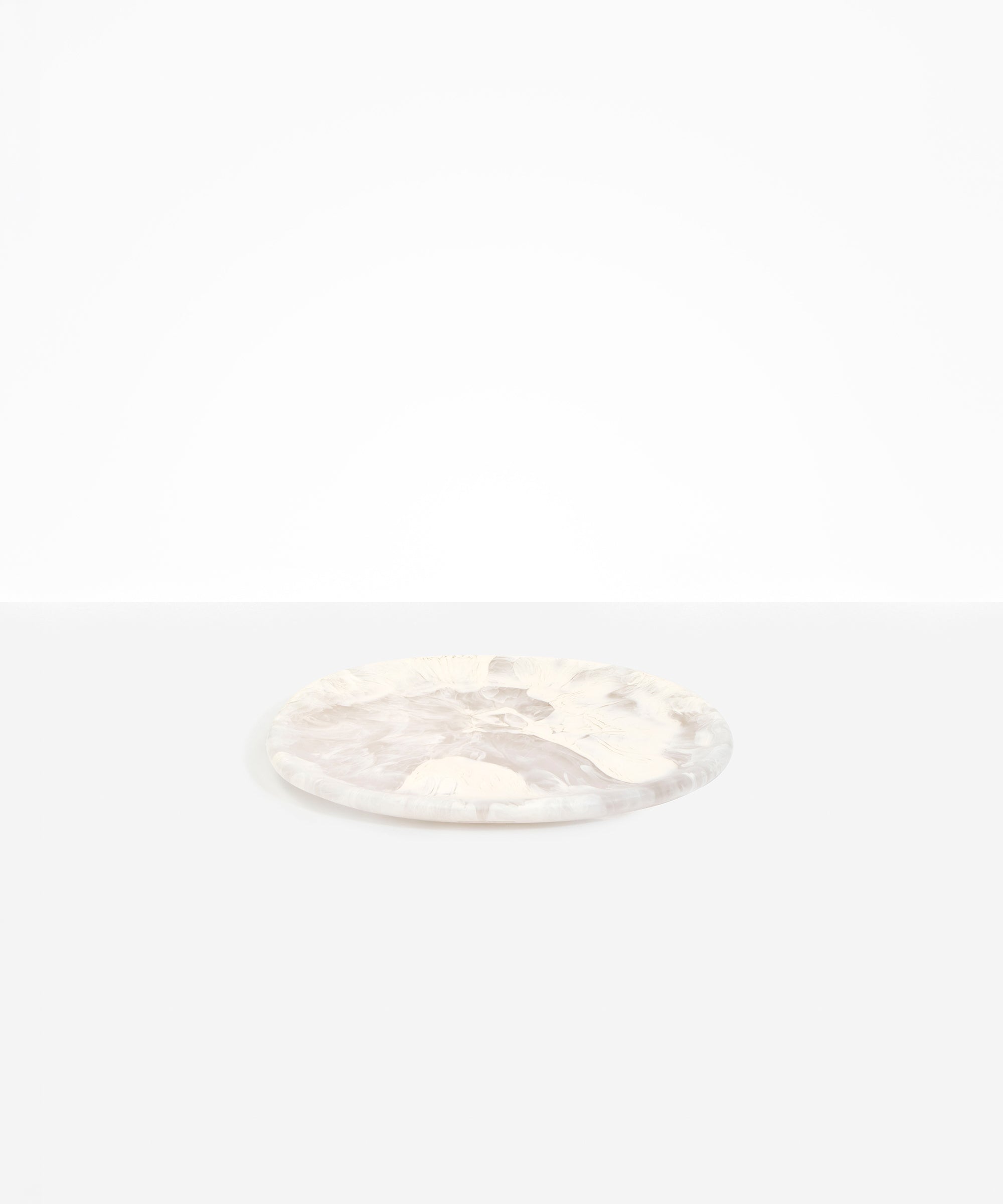 Dinosaur Designs Rock Plate in Pool — handcrafted marbled off-white resin oval flat serving plate with rounded organic edge