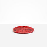 Dinosaur Designs Rock Plate in Cranberry — handcrafted marbled red resin oval flat serving plate with rounded organic edge