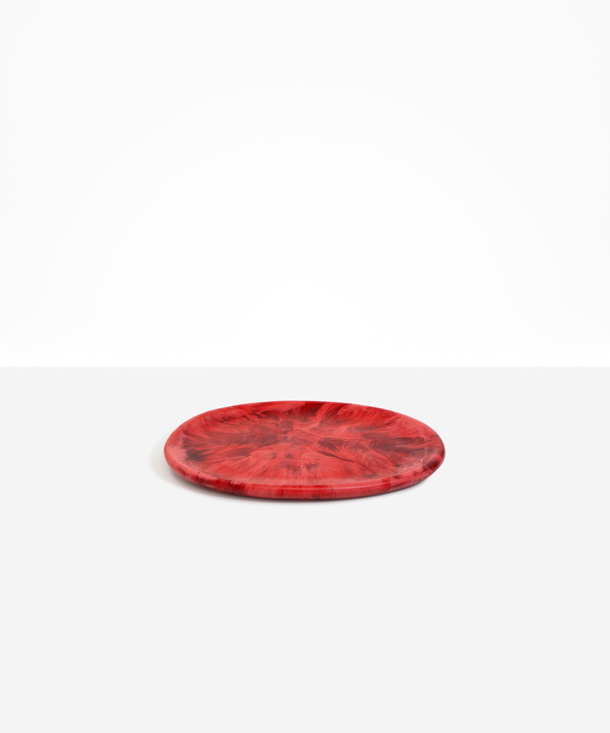 Dinosaur Designs Rock Plate in Cranberry — handcrafted marbled red resin oval flat serving plate with rounded organic edge