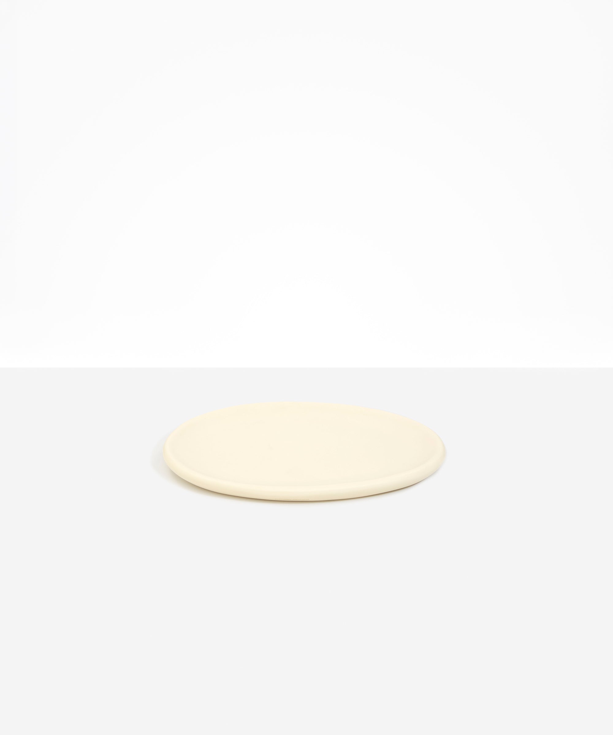 Dinosaur Designs Rock Plate in Cream — handcrafted cream resin oval flat serving plate with rounded organic edge