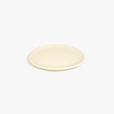 Dinosaur Designs Rock Plate in Cream — handcrafted cream resin oval flat serving plate with rounded organic edge