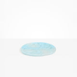 Dinosaur Designs Rock Plate in Pool — handcrafted marbled blue resin oval flat serving plate with rounded organic edge