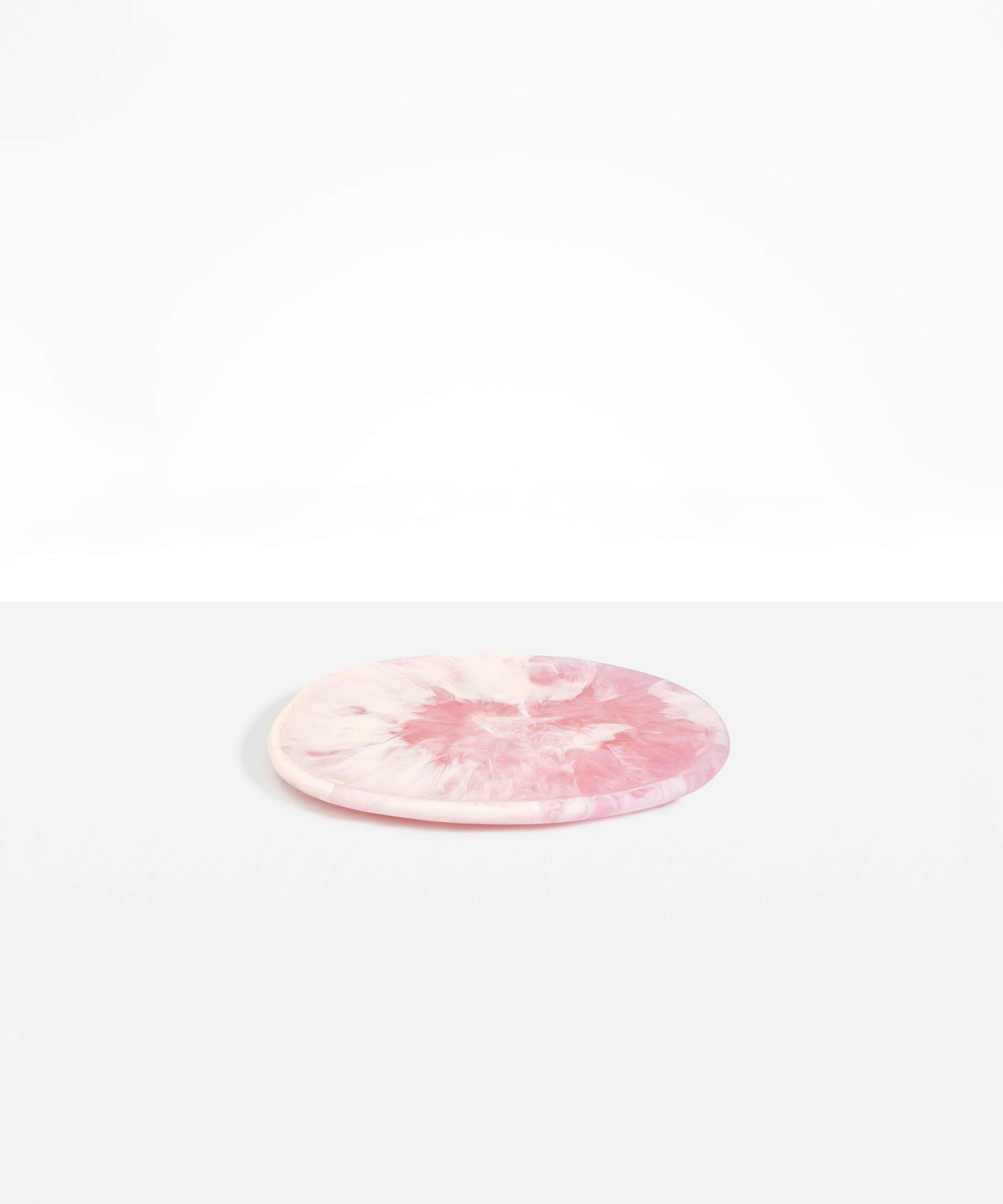 Dinosaur Designs Rock Plate in Shell Pink — handcrafted marbled pink resin oval flat serving plate with rounded organic edge