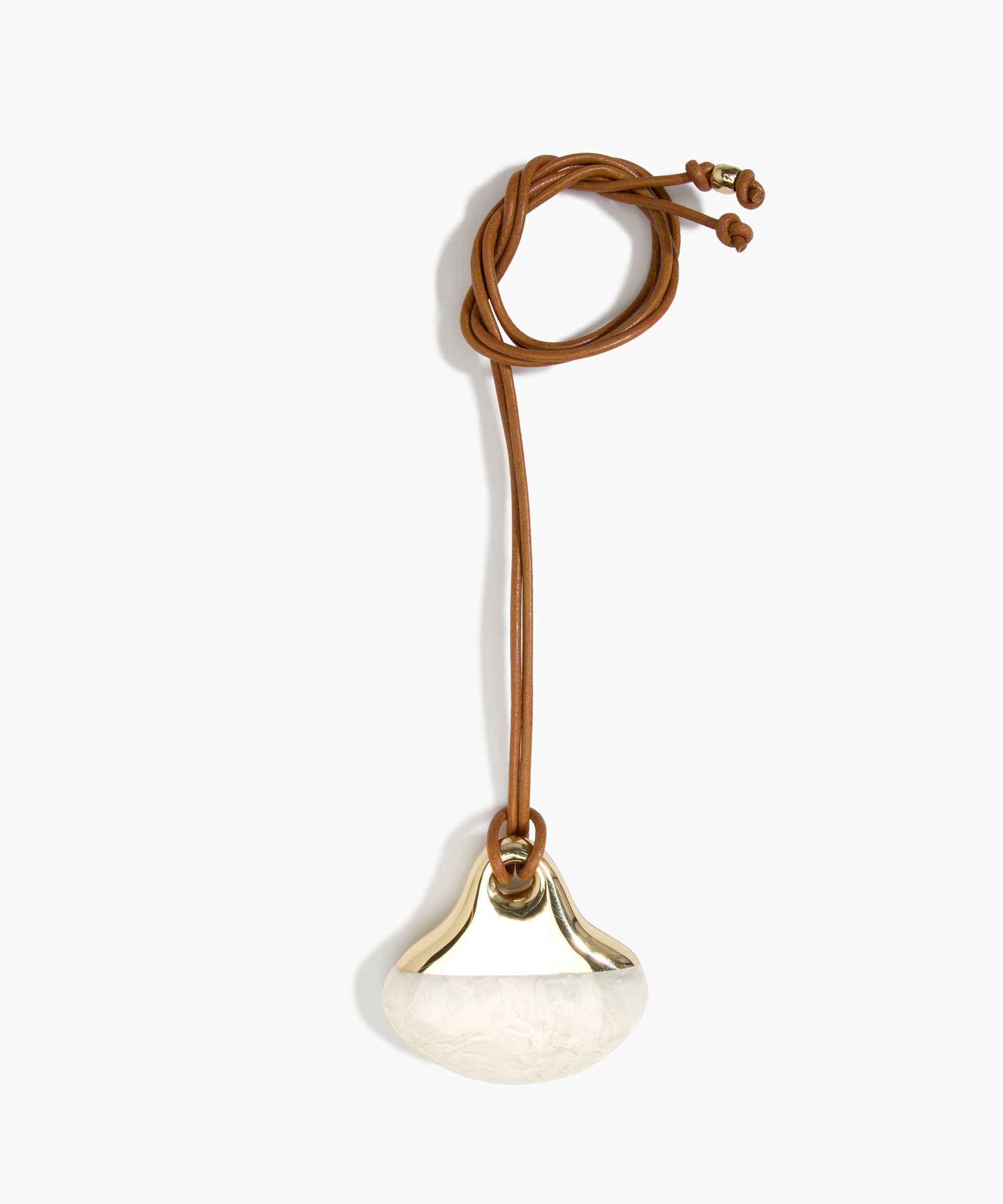 Dinosaur Designs Large Polished Lotus Pendant on Leather in Chalk Swirl with Brass hardware — marbled off-white resin half-crescent pendant with polished brass setting on an adjustable tan leather cord