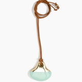 Dinosaur Designs Large Polished Lotus Pendant on Leather in Mint with Brass hardware — marbled mint blue resin half-crescent pendant with polished brass setting on an adjustable tan leather cord