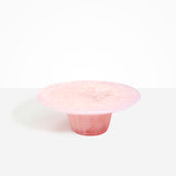 Dinosaur Designs Temple Cake Stand in Blossom — handcrafted marbled pink resin cake stand with wide flat platform and tapered pedestal base
