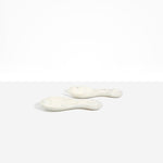 Dinosaur Designs Rock Servers in Chalk Swirl — handcrafted marbled off-white resin salad server set with rounded bulb handles, fork and spoon.