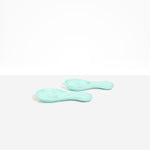 Dinosaur Designs Rock Servers in Mint — handcrafted marbled mint blue resin salad server set with rounded bulb handles, fork and spoon.