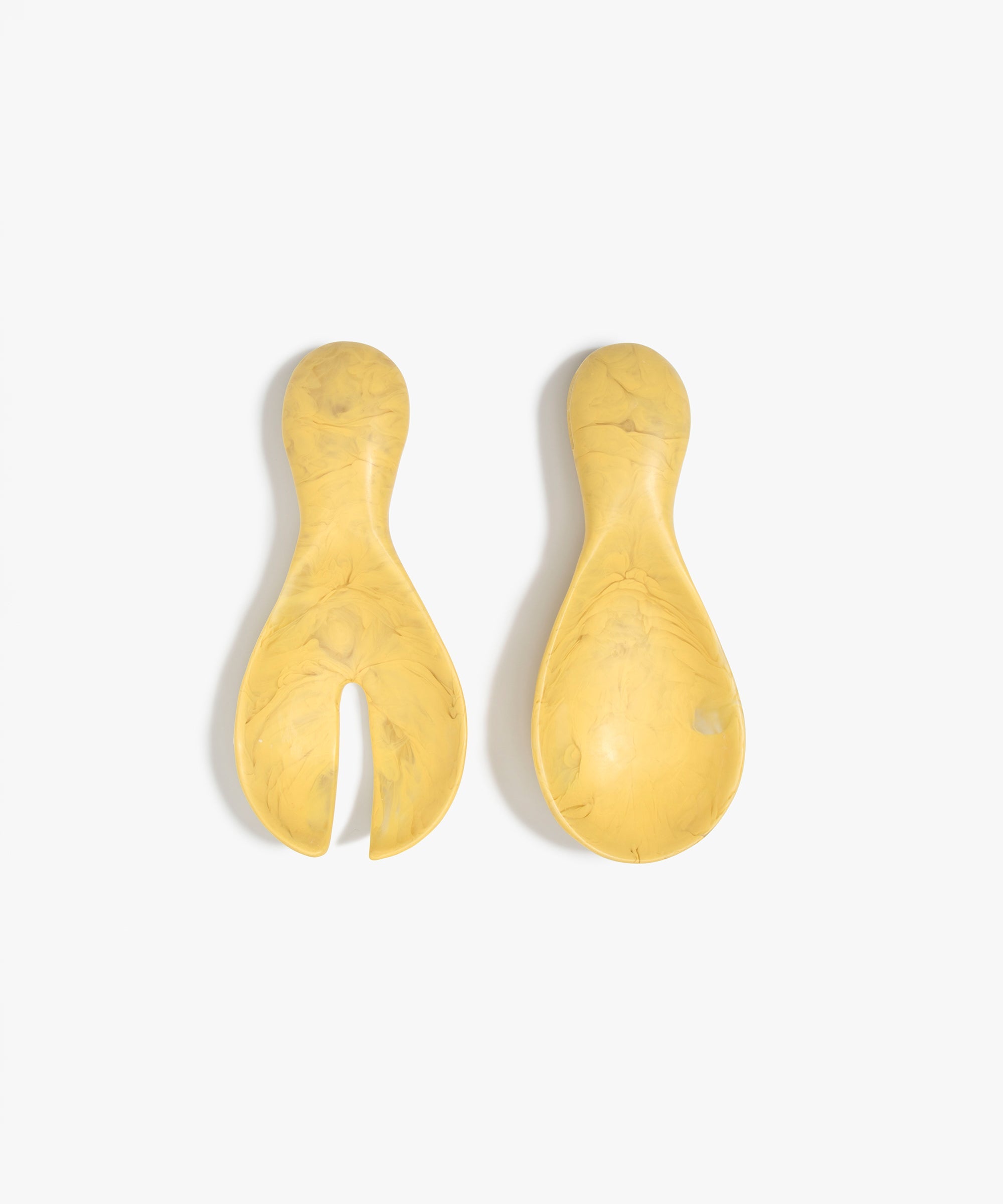 Dinosaur Designs Rock Servers in Pollen — handcrafted marbled yellow resin salad server set with rounded bulb handles, fork and spoon.