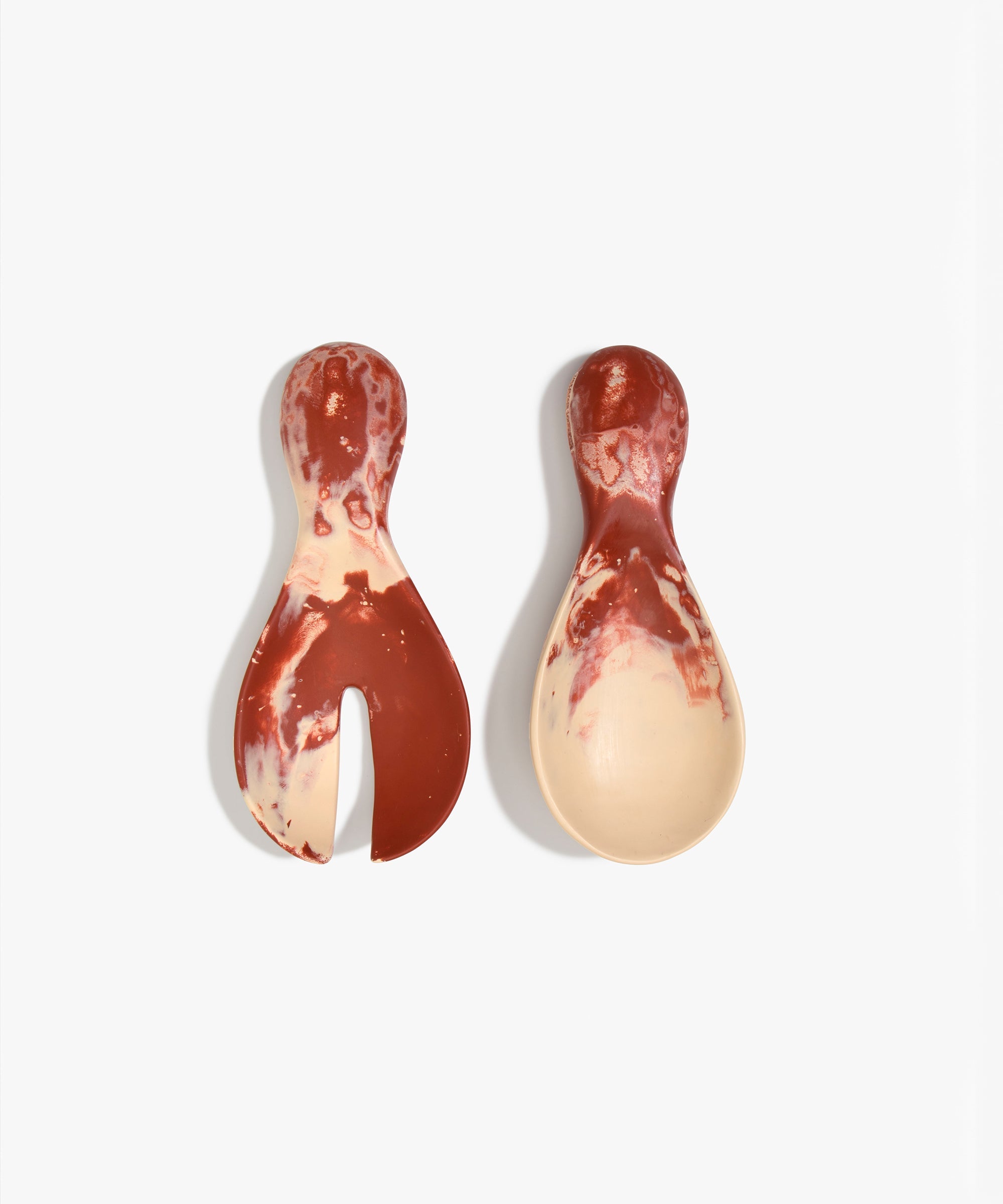 Dinosaur Designs Rock Servers in Rust — handcrafted marbled terracotta red and cream resin salad server set with rounded bulb handles, fork and spoon.