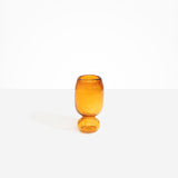 Dinosaur Designs Small Glass Rockpool Vase in Amber — handblown amber glass vase with rounded bulbous body and small spherical pedestal base