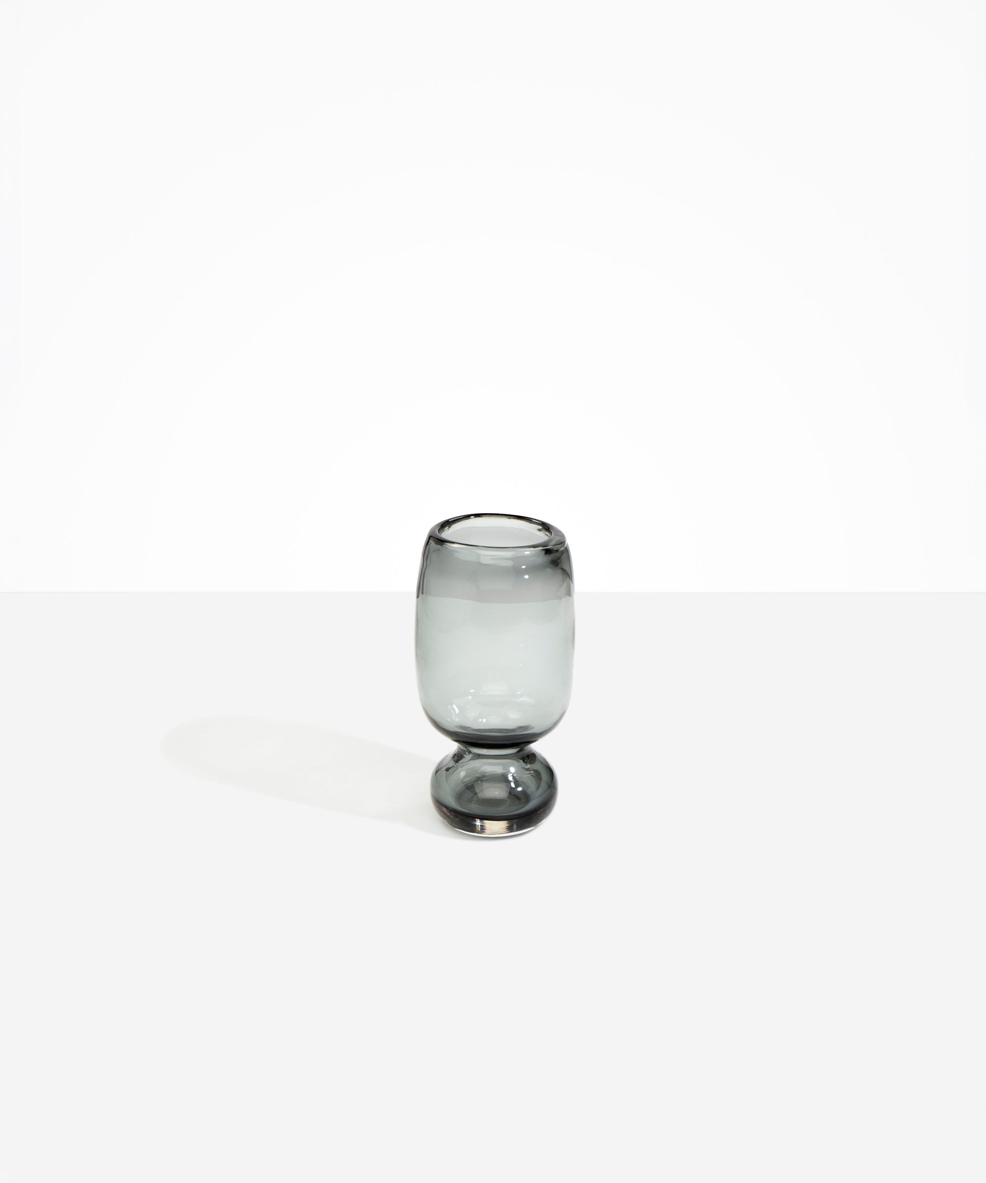 Dinosaur Designs Small Glass Rockpool Vase in Clear Black — handblown transparent black glass vase with rounded bulbous body and small spherical pedestal base