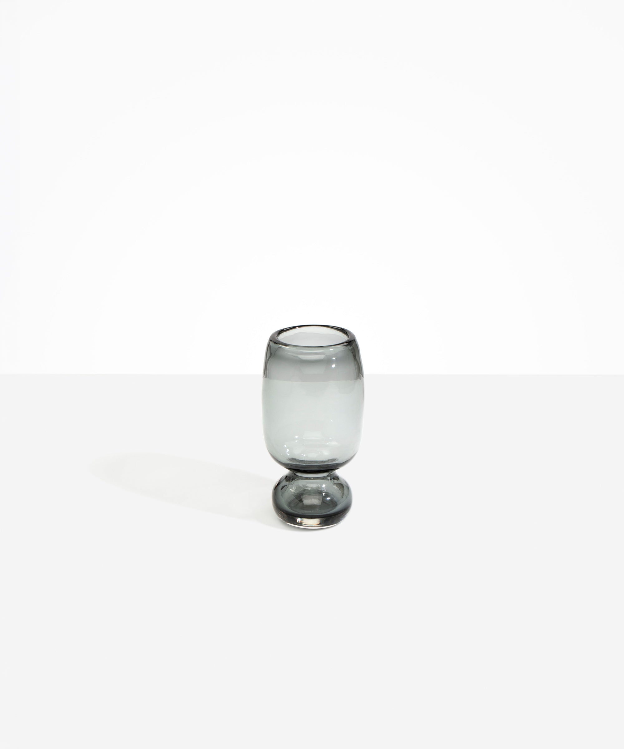 Dinosaur Designs Small Glass Rockpool Vase in Clear Black — handblown transparent black glass vase with rounded bulbous body and small spherical pedestal base