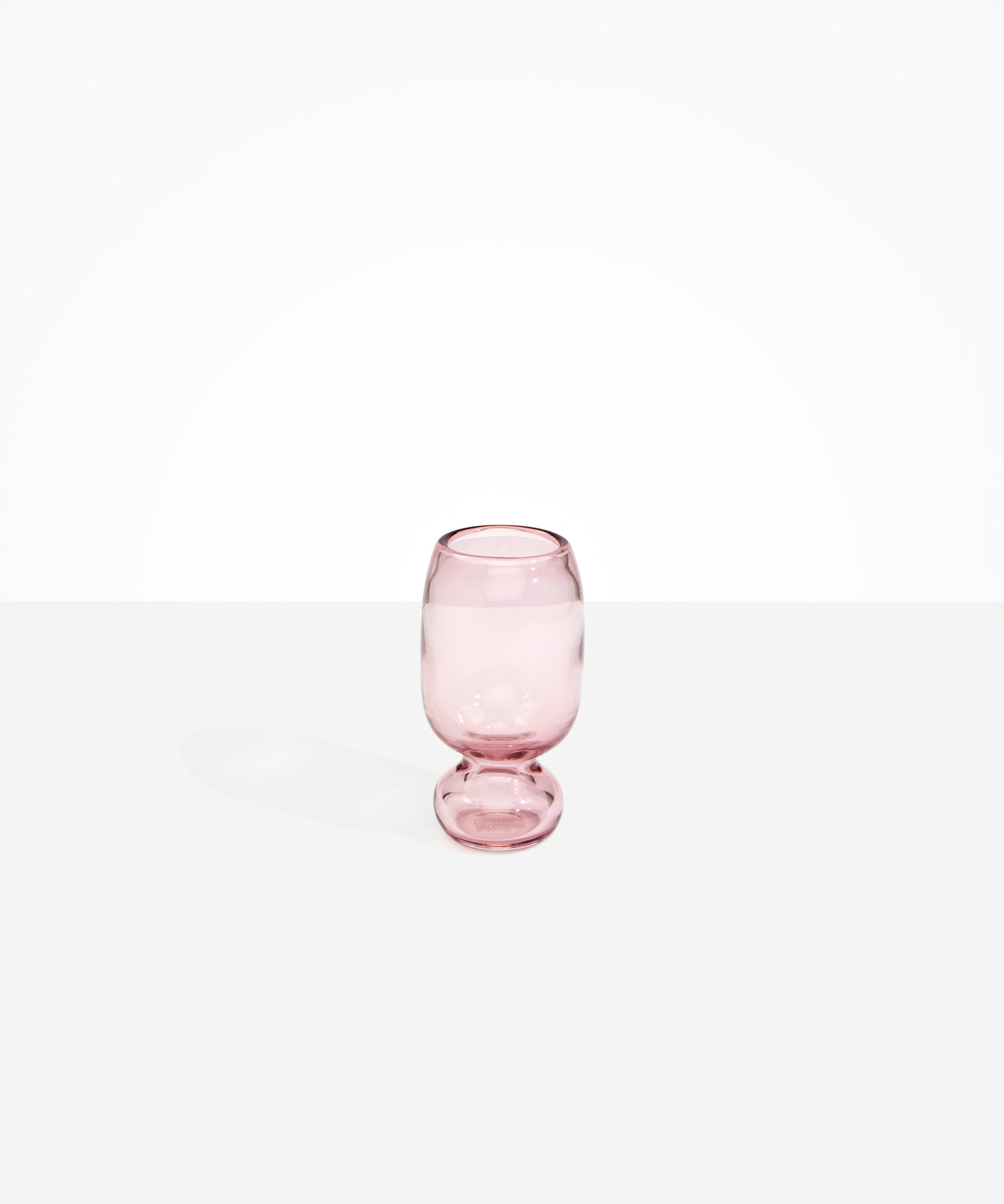 Dinosaur Designs Small Glass Rockpool Vase in Pink — handblown transparent pink glass vase with rounded bulbous body and small spherical pedestal base